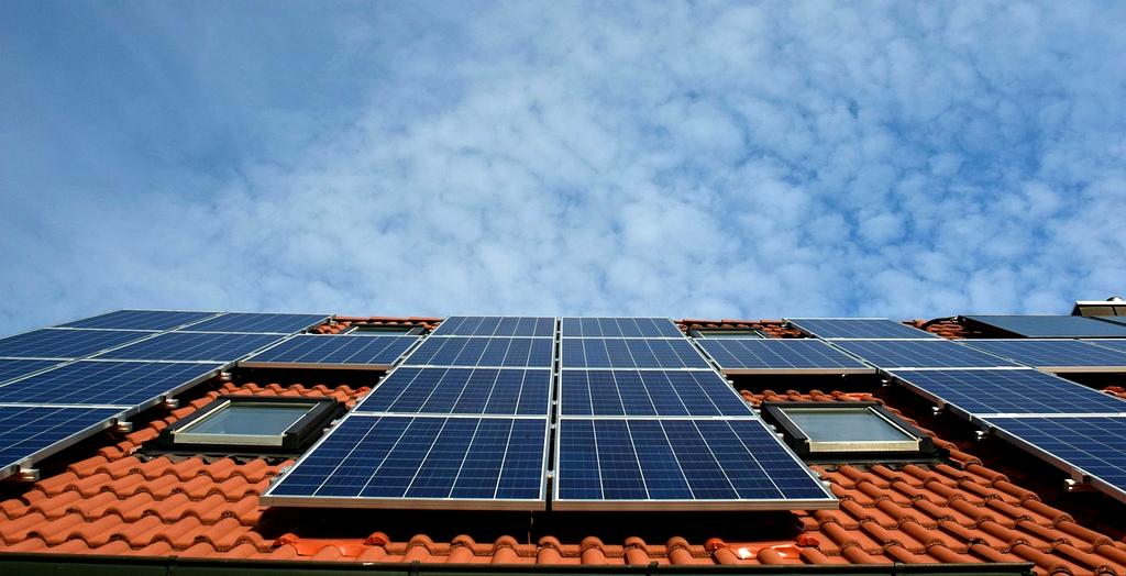 Solar panels installed on residential rooftops under a clear blue sky